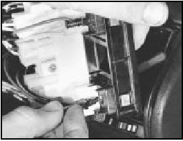 15.54B Disconnecting a fibre optic cable from its holder on the 1301 cc Turbo
